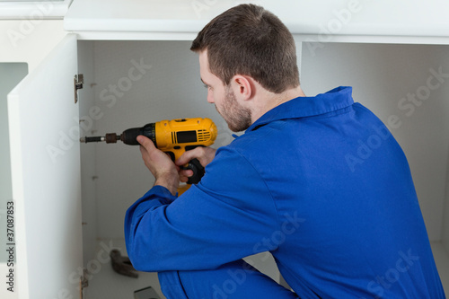 Handyman fixing a door