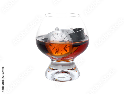 Watch in glass with cognac photo