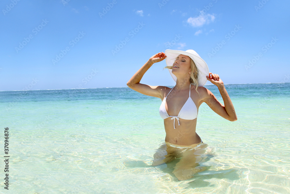 Beautiful blond woman in bikini by blue lagoon Beautiful blond woman in bikini by blue lagoon