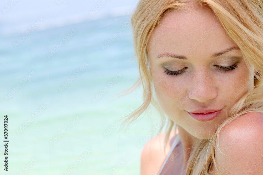 Beautiful blond woman in ocean water