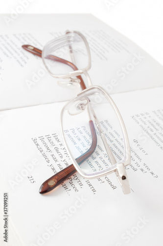 Glasses on open book photo