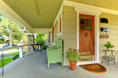 Covered front porch of theold craftsman style home. photo