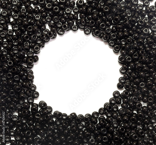 black pearls scattered on a white background with place for text