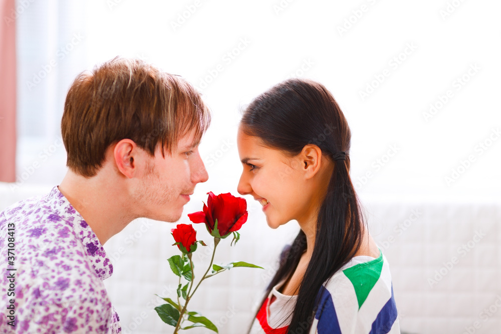 Young man presenting a flower to his girlfriend Young man presenting a flower to his girlfriend