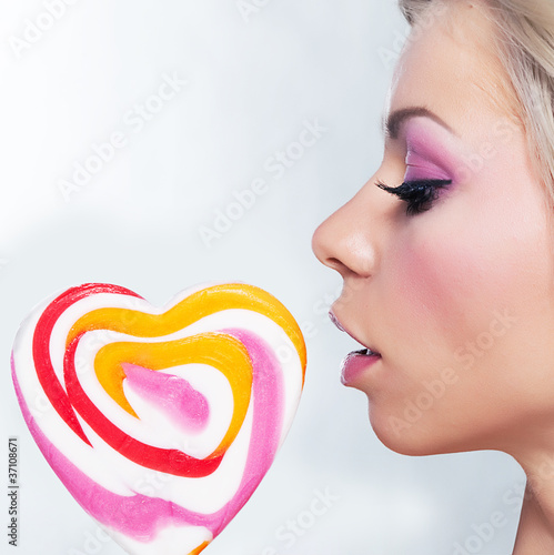 Young beautiful girl with candy photo