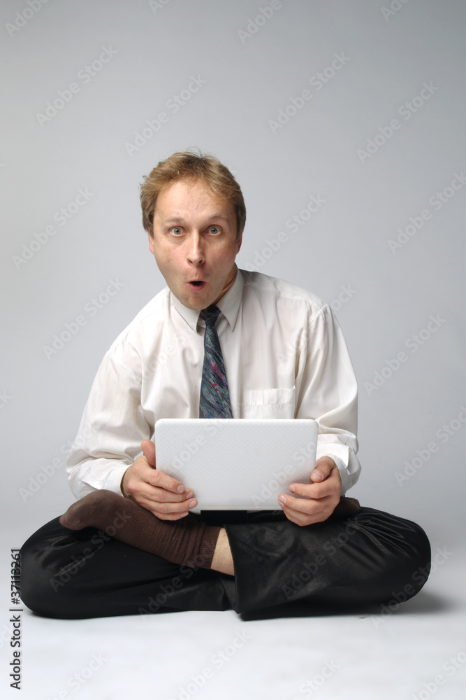 Young businessman yoga before an open notebook Young businessman yoga before an open notebook