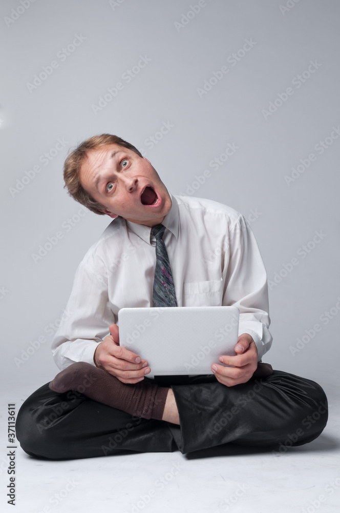 Young businessman yoga before an open notebook Young businessman yoga before an open notebook