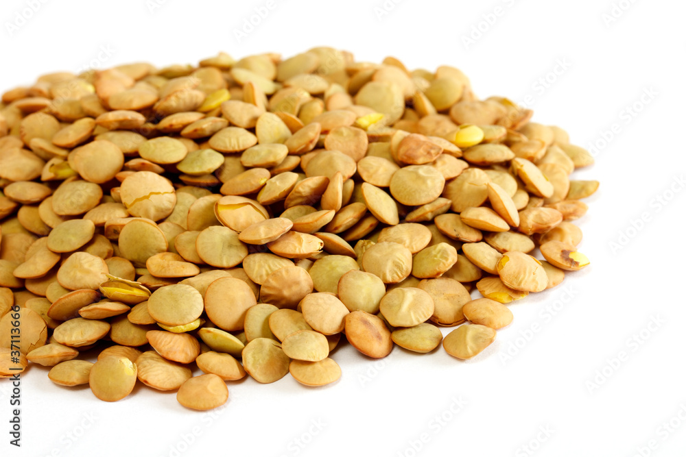 Brown lentils scattered on white background Brown lentils scattered on white background