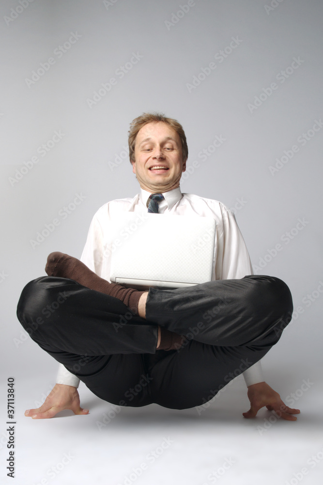 Young businessman yoga before an open notebook Young businessman yoga before an open notebook