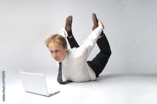 Young businessman yoga before an open notebook