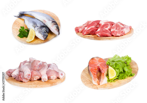 set with different raw fish, chicken and meat
