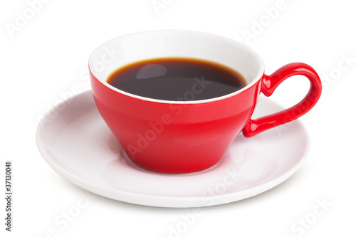 Red cup with instant coffee on a white saucer