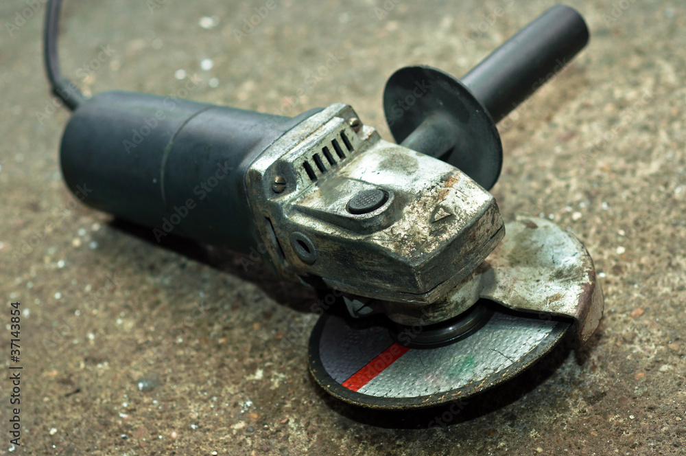 A used circular saw on concrete floor A used circular saw on concrete floor