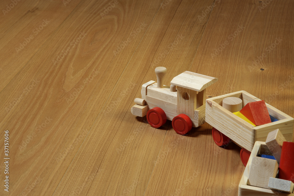 woodden train toy on parquet.