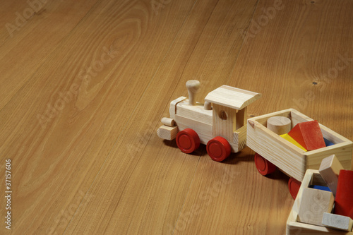 woodden train toy on parquet.