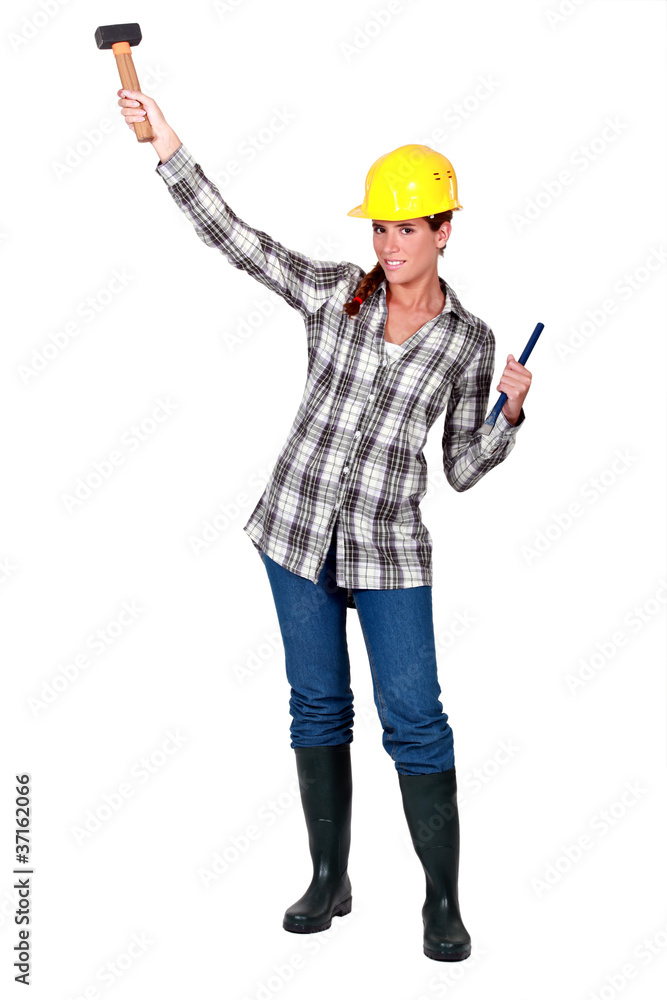 A female construction worker with a hammer. A female construction worker with a hammer.