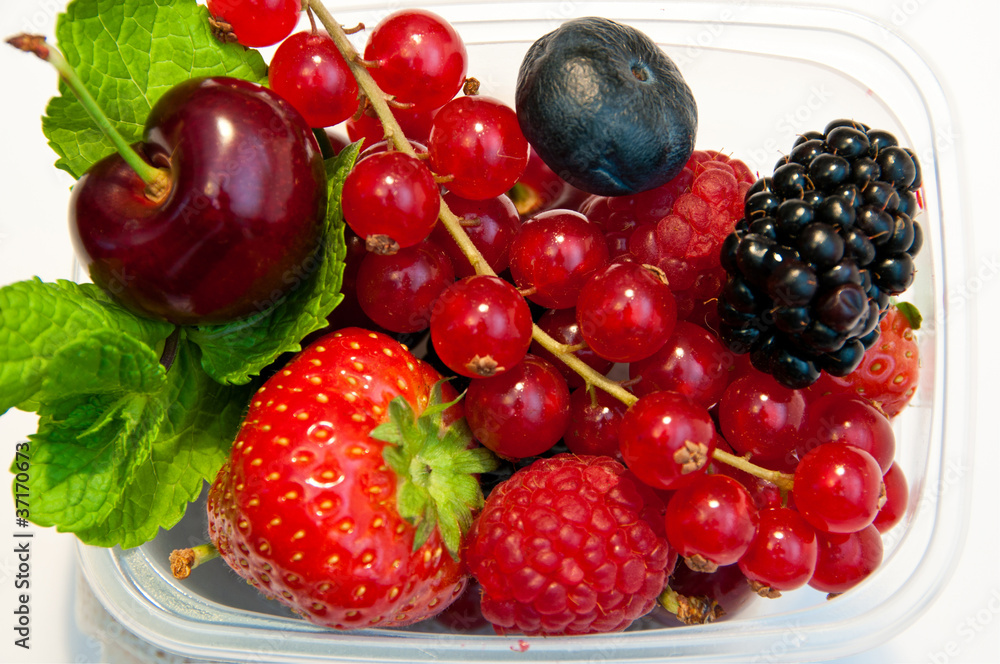 berries in a plastic box on a white background berries in a plastic box on a white background