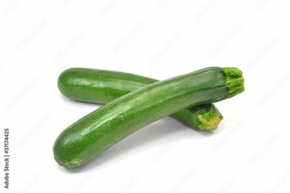 Two whole courgettes on a white background Two whole courgettes on a white background
