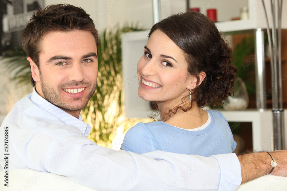 Smiling couple sitting on Smiling couple sitting on