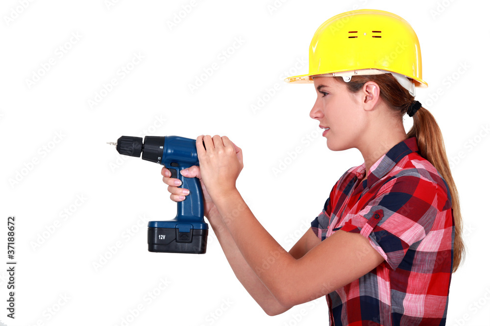 Woman with a cordless drill Woman with a cordless drill