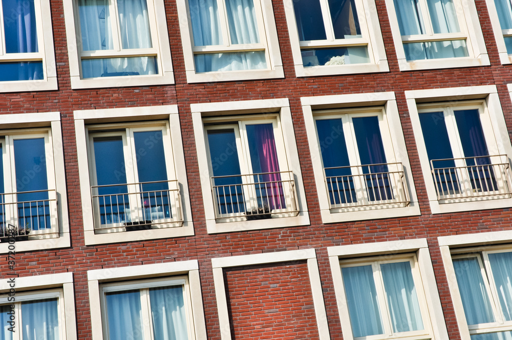 Fototapeta premium close-up on the wall with the windows of modern buildings