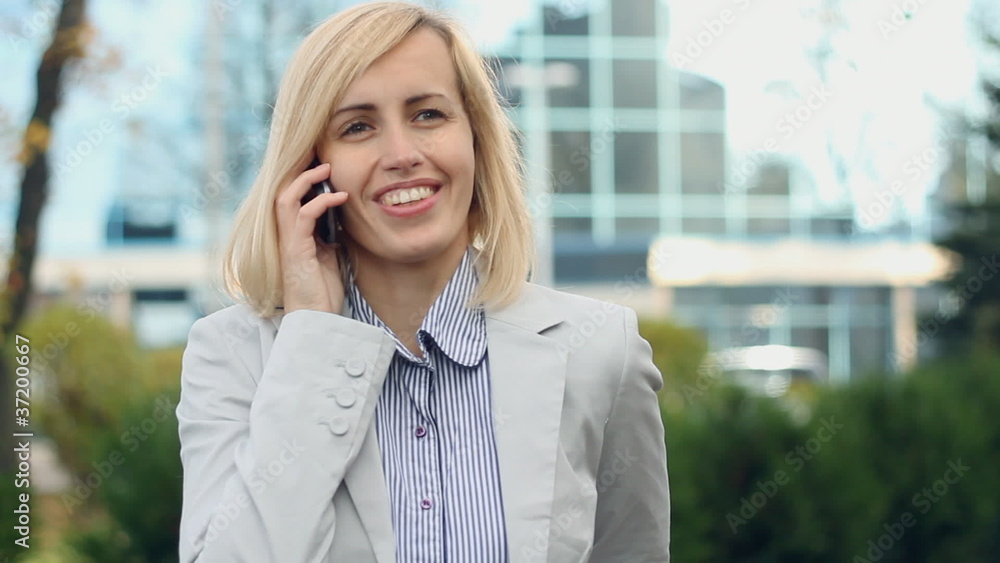 Attractive businesswoman talking on cellphone in the city Attractive businesswoman talking on cellphone in the city
