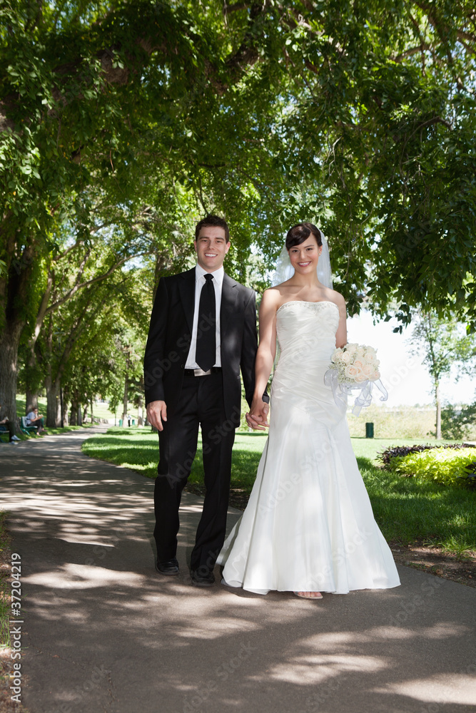 Naklejka premium Newlywed Young Couple Holding Hands
