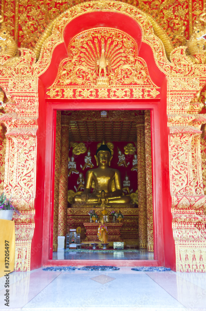 Golden Buddha in golden arch.