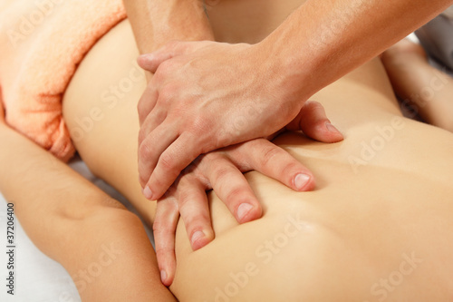 hands of masseur massaging woman