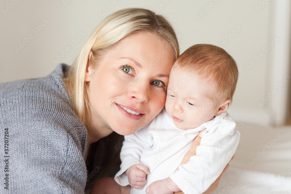 Mother holding her newborn close Mother holding her newborn close