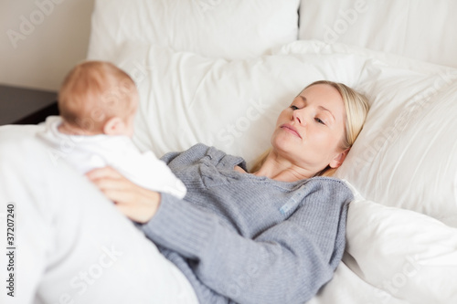 Mother lying in the bed with her baby
