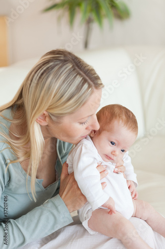 Mother on the sofa holding her baby