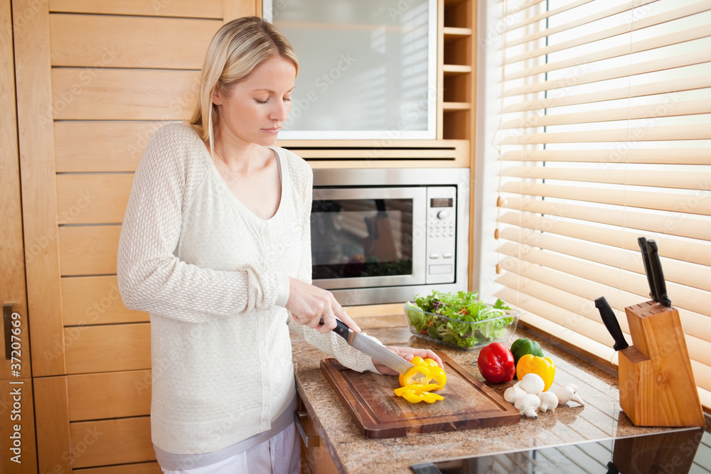 Side view of woman slicing bell pepper Side view of woman slicing bell pepper