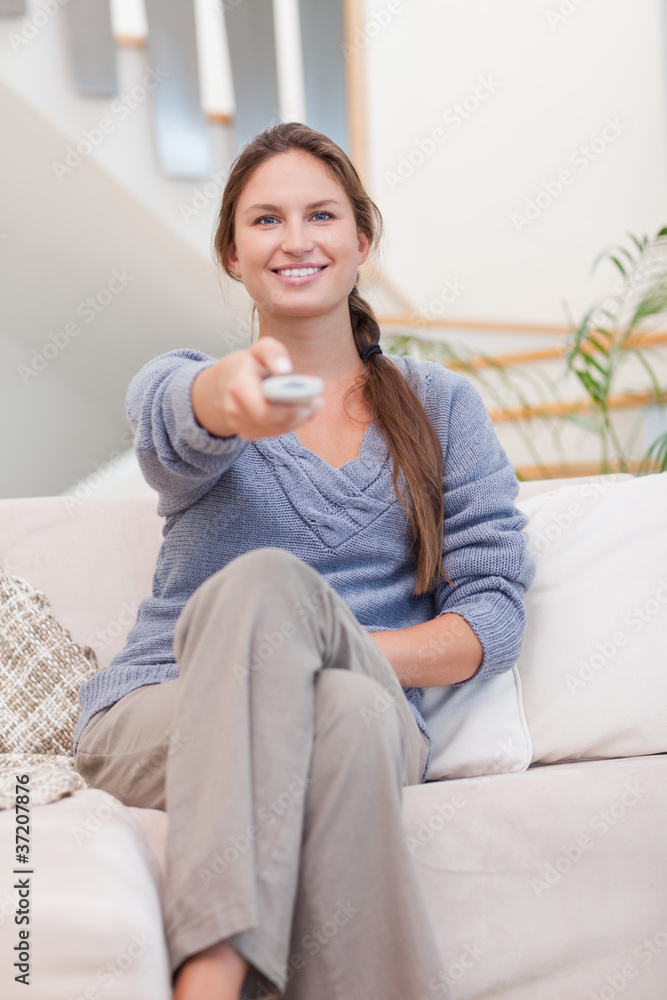 Portrait of a happy woman woman watching TV