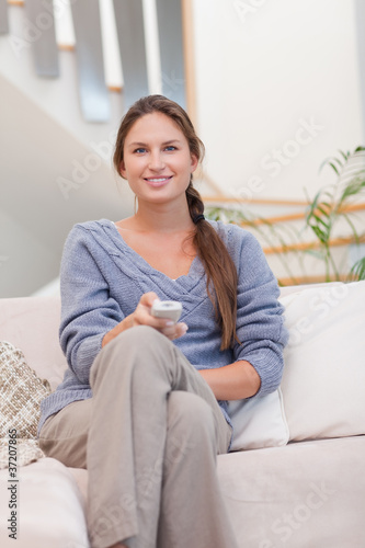 Portrait of a smiling woman woman watching TV