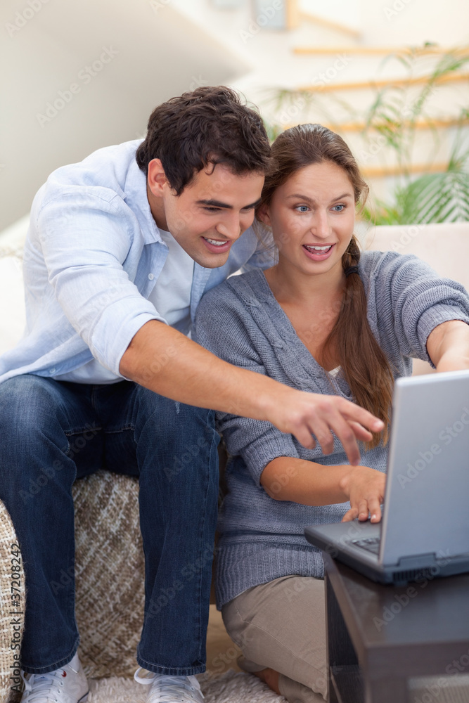 Portrait of a surprised couple using a notebook Portrait of a surprised couple using a notebook