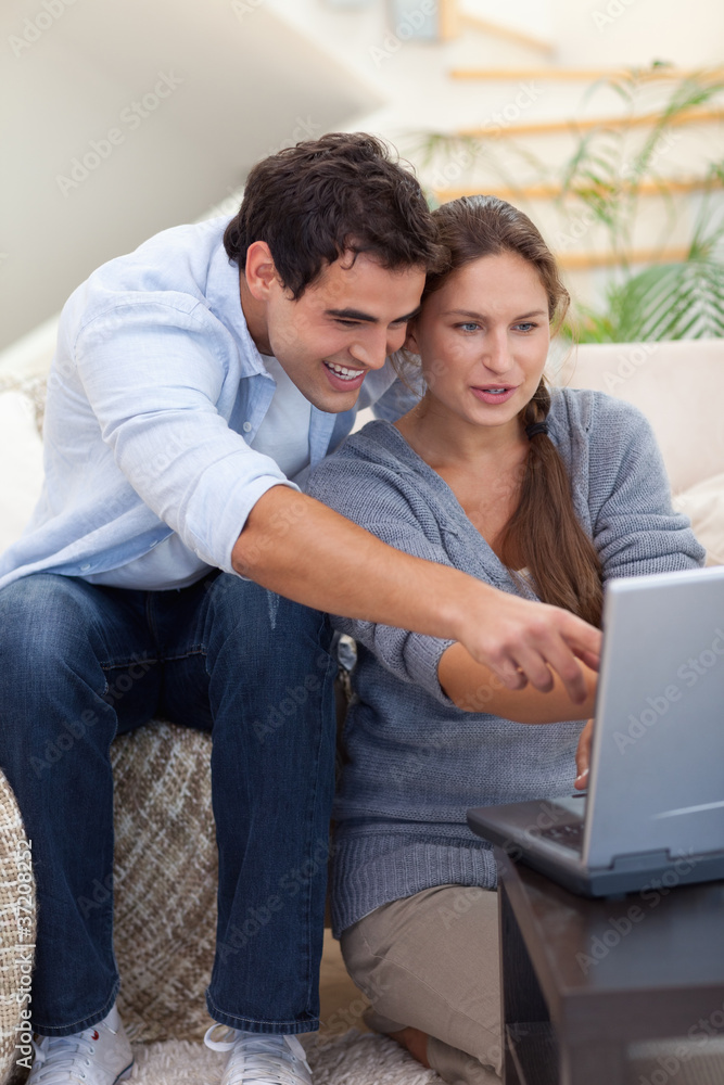 Portrait of a startled couple using a laptop Portrait of a startled couple using a laptop