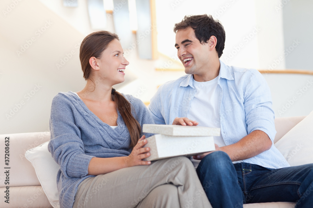 Young man surprising his fiance with a present Young man surprising his fiance with a present
