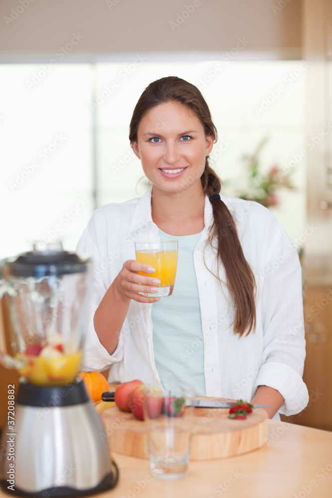 Portrait of a young woman drinking fresh fruits juice Portrait of a young woman drinking fresh fruits juice