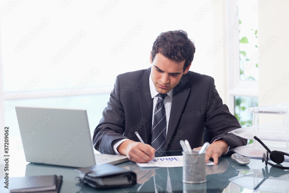 Businessman working on statistics Businessman working on statistics
