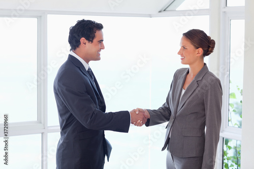 Side view of trades partner shaking hands