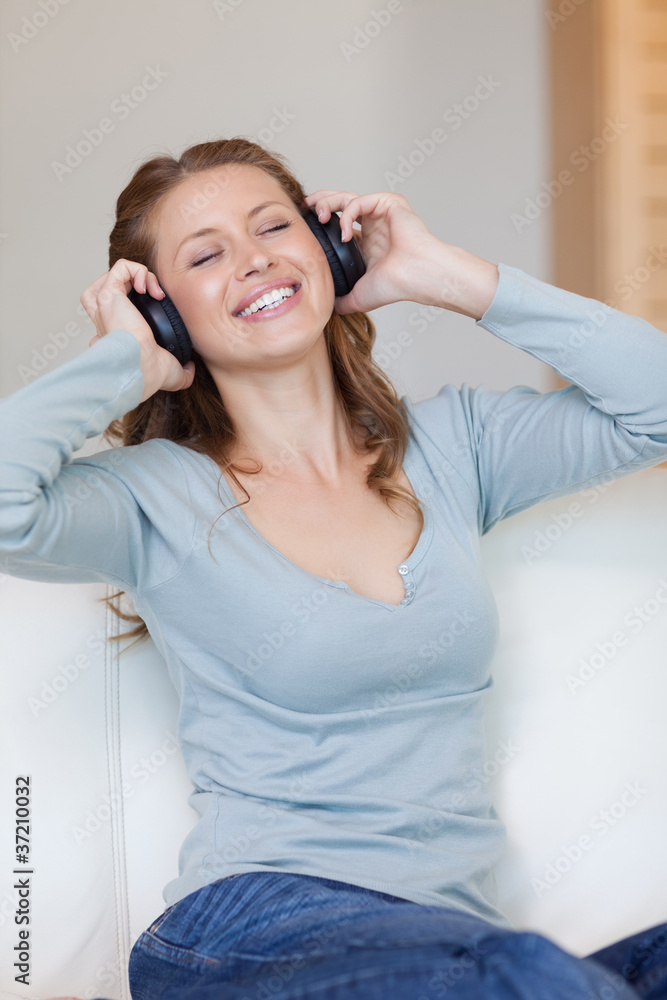 Young woman enjoying music on the sofa Young woman enjoying music on the sofa
