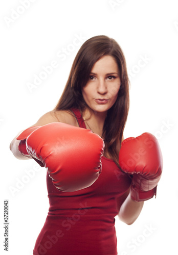 Confident young woman with boxing gloves
