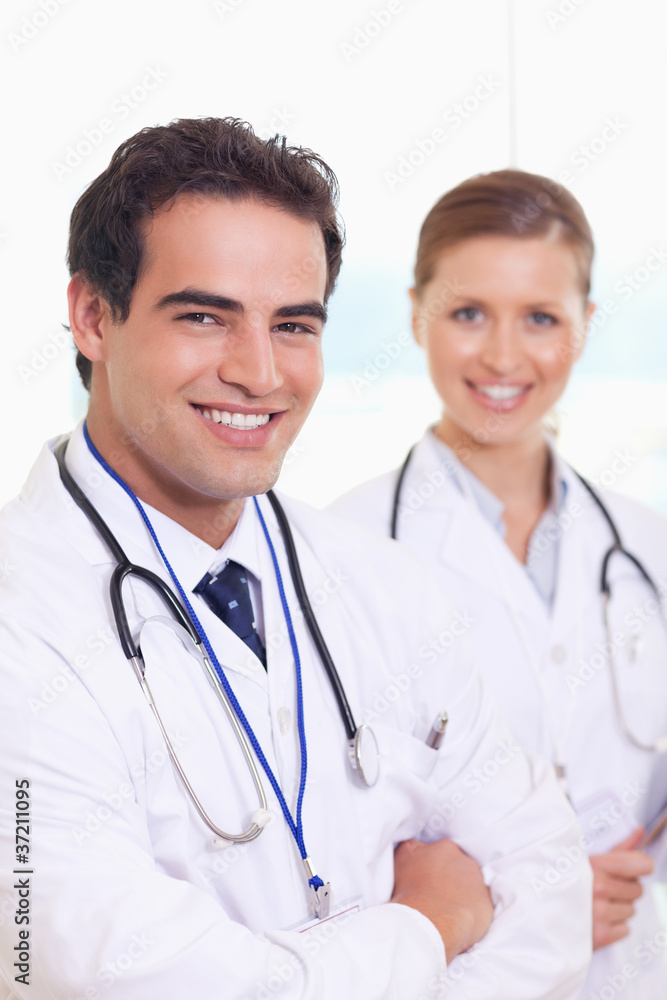 Smiling medical team standing next to each other Smiling medical team standing next to each other