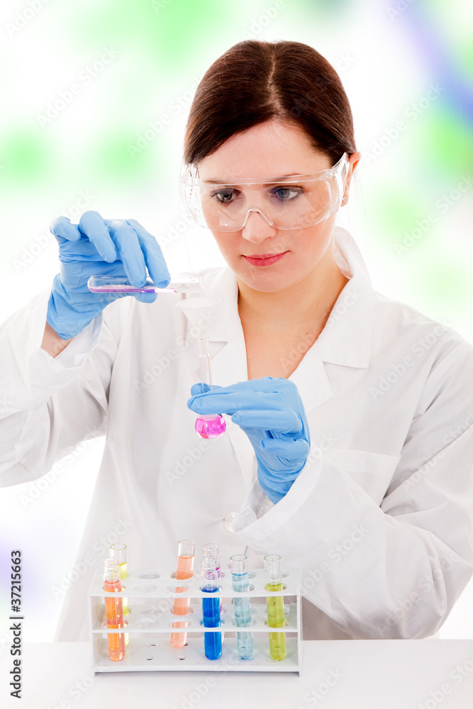 young female researcher making experiences in a lab young female researcher making experiences in a lab