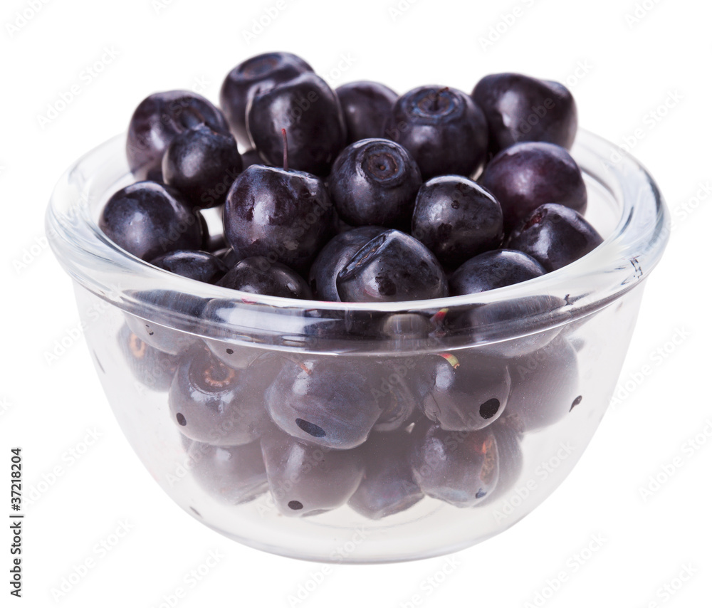 Bilberry fruit in transparent glass, isolated on white macro Bilberry fruit in transparent glass, isolated on white macro