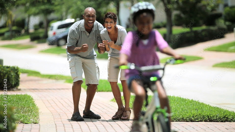 African American Child Practicing on her Bicycle African American Child Practicing on her Bicycle