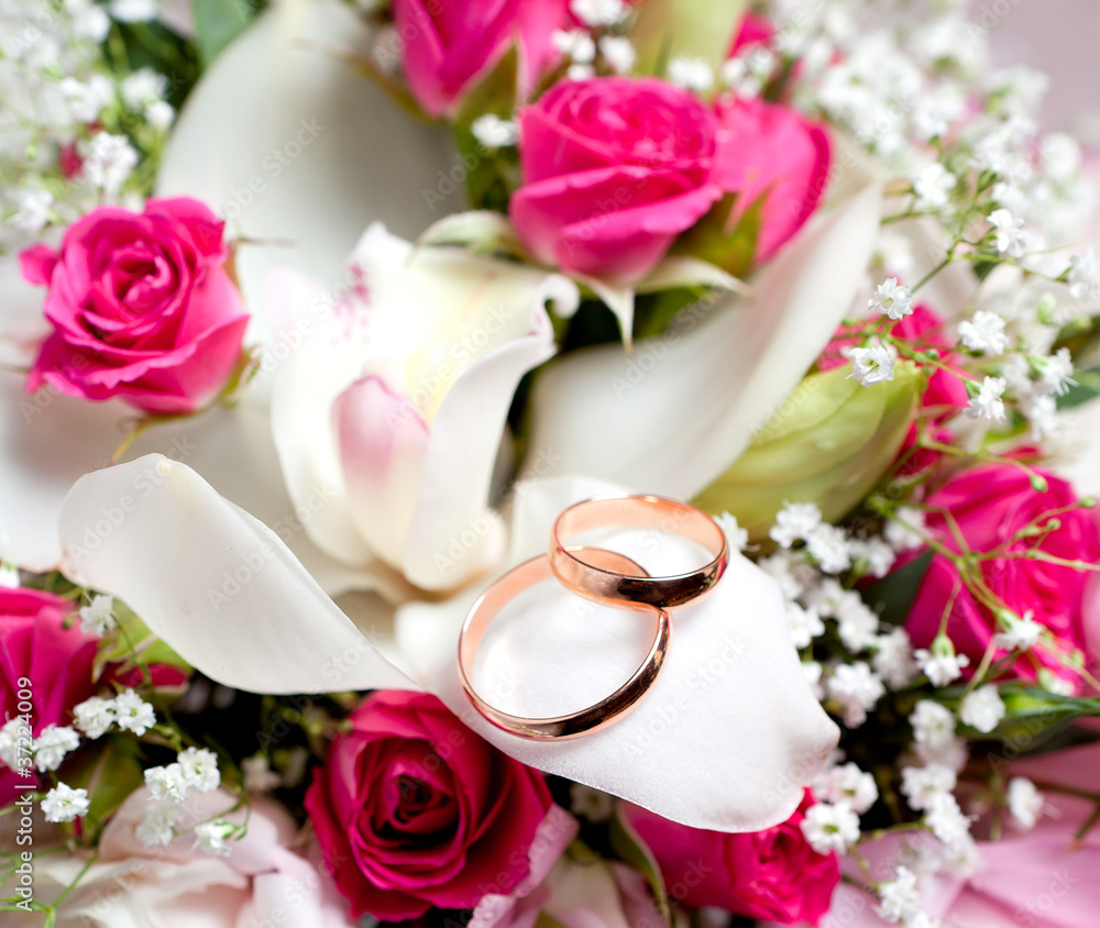 Gold wedding rings on flower Gold wedding rings on flower