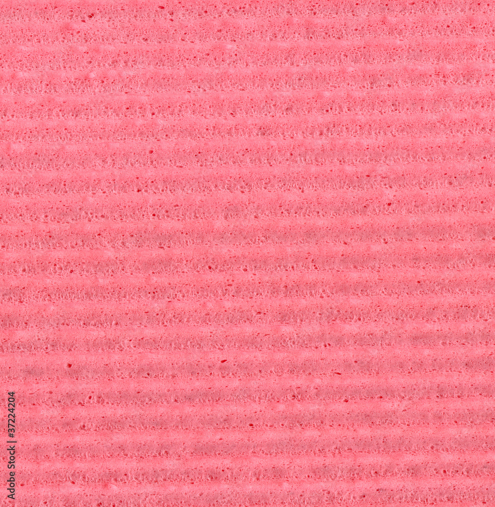 Fototapeta premium A detailed macro shot of a rough, granular pink paper surface featuring a prominent horizontal ribbed pattern, ideal for use as a textured background.