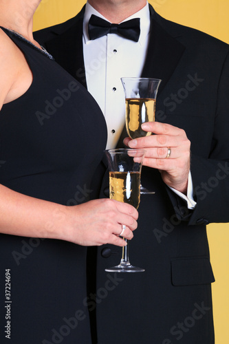 Couple in evening dress holding Champagne